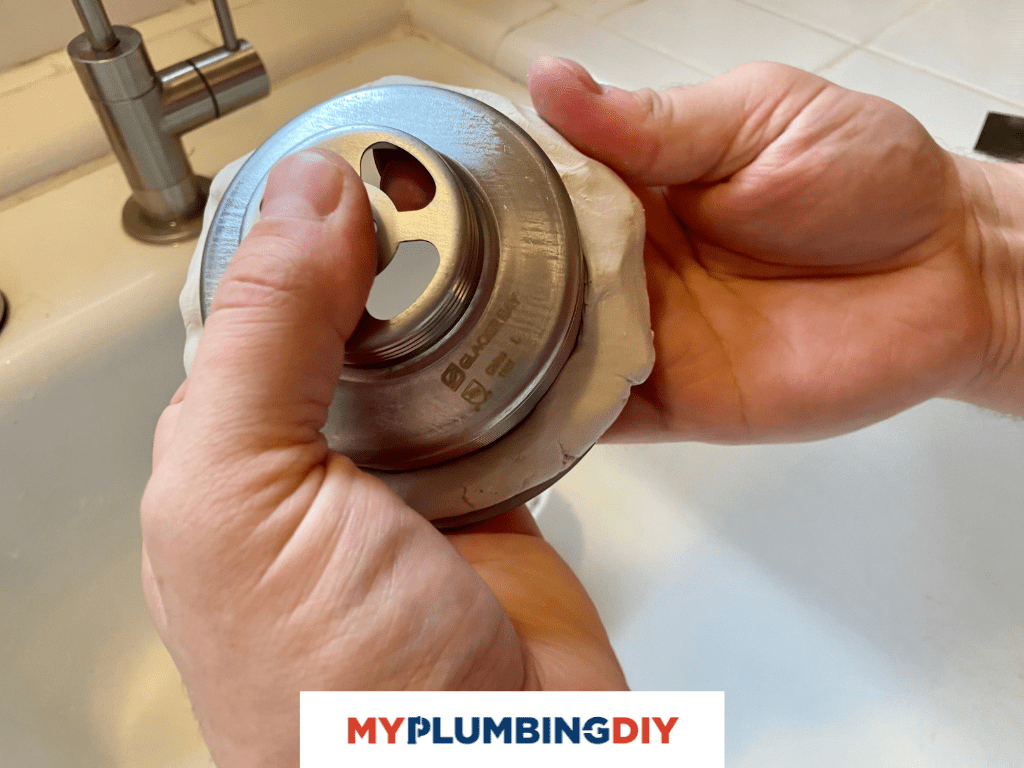 placing plumbers putty on sink drain