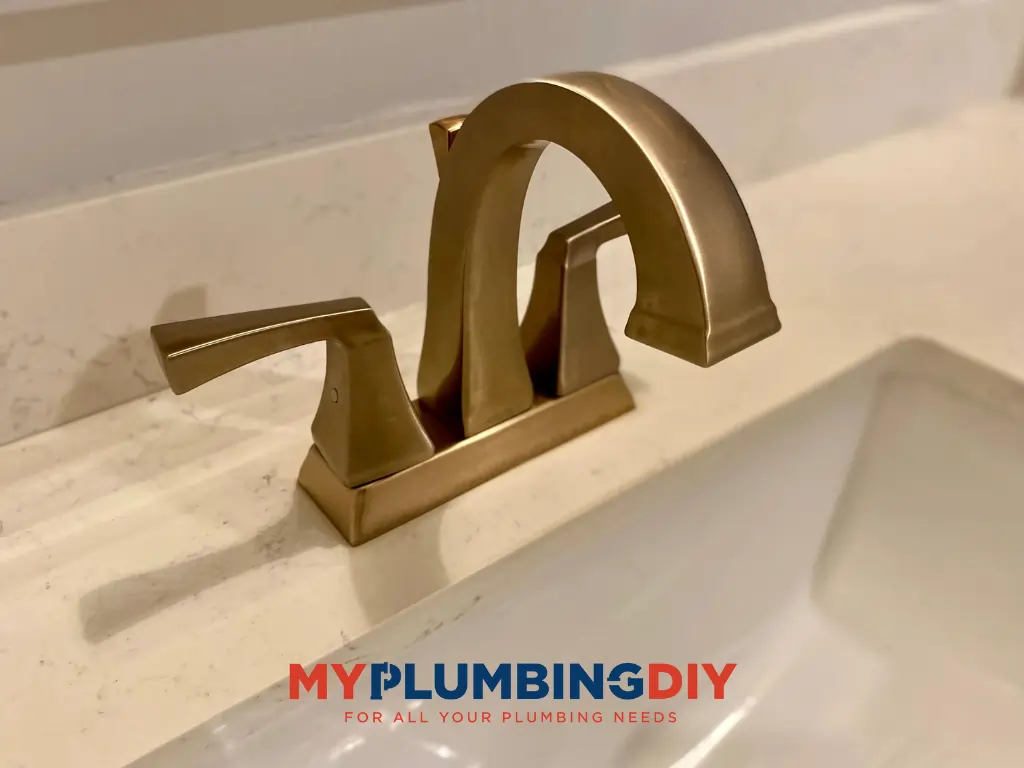 4 inch centerset gold Delta faucet with logo