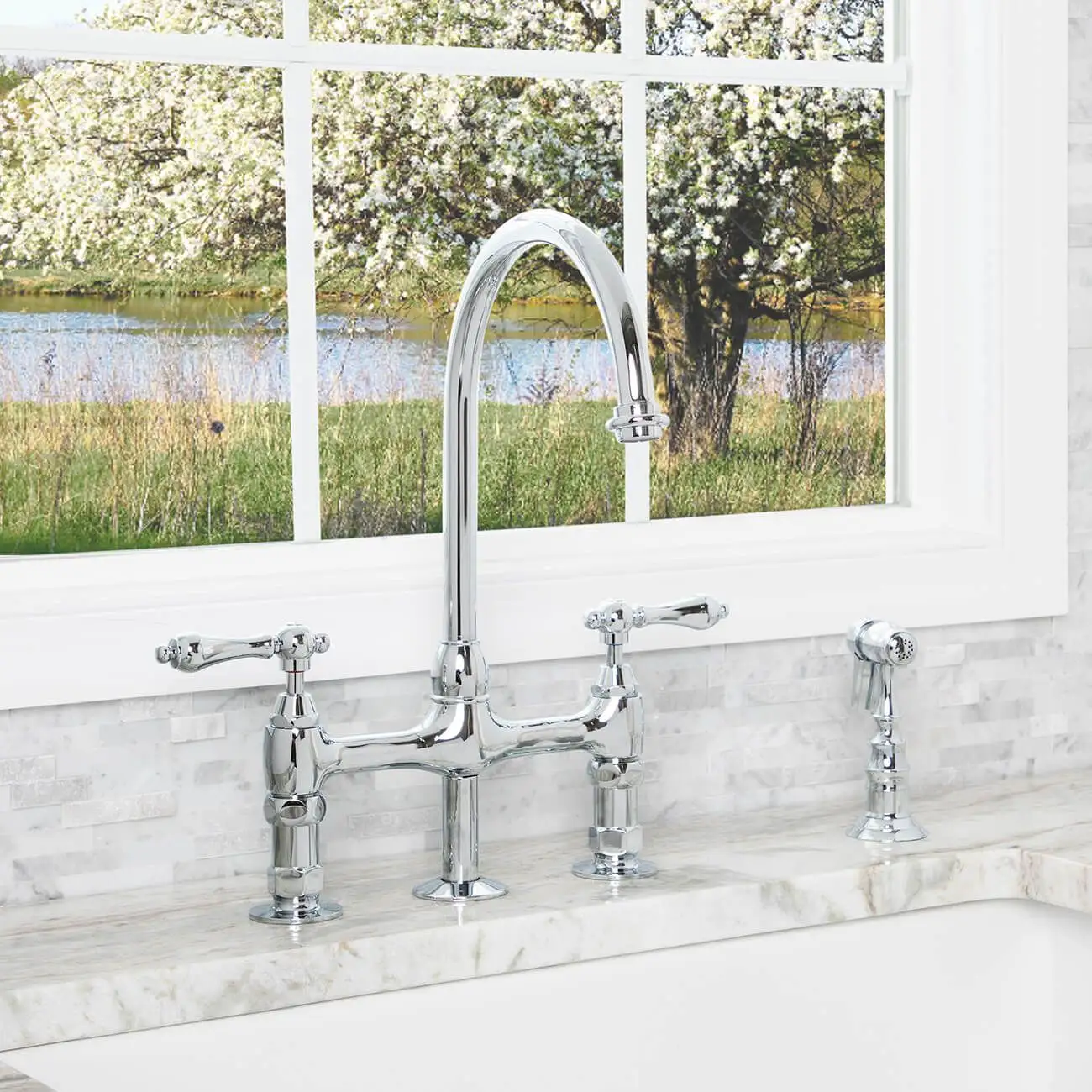 bridge faucet on a marble countertop with a window behind