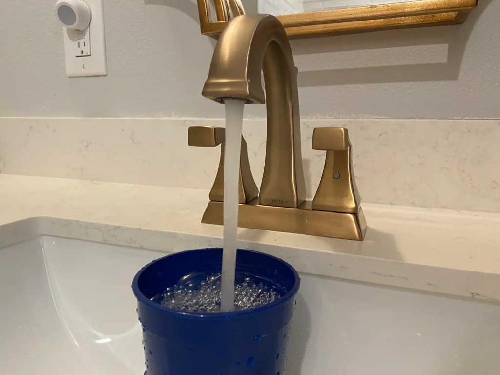 faucet filling up a cup of water