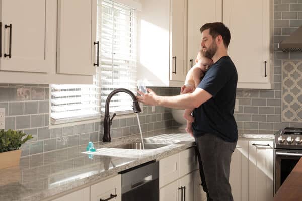 dad touching faucet to turn on