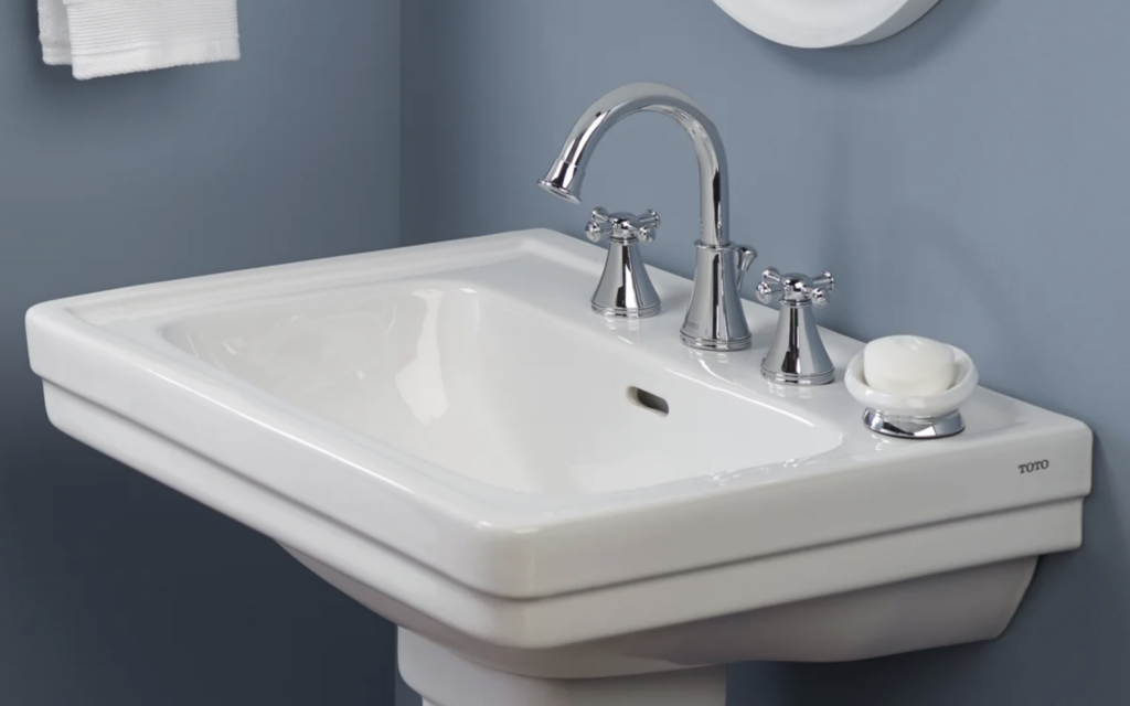 Toto faucet on white pedestal sink